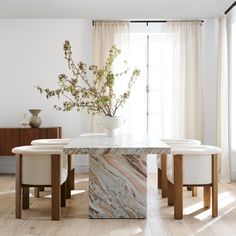 a dining room with marble table and chairs