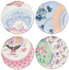 four plates with different designs on them, one is blue and the other is pink