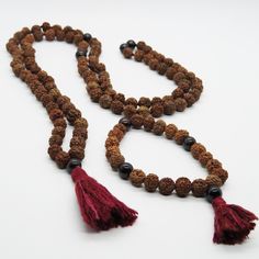 Beads: Rudraksha seedsStone: CarnelianMeaning: Grounding, passion and devotionChakra: Root (1st)Tassel: Ahimsa silk, cruelty-free Traditional Mala With Natural Stones For Meditation, Spiritual Hand Knotted Mala As Gift, Bohemian Adjustable Mala For Puja, Traditional Adjustable Mala For Healing, Adjustable Traditional Mala For Healing, Adjustable Bohemian Mala For Blessings, Adjustable Hand Knotted Mala For Meditation, Bohemian Red Mala For Rituals, Multicolor Spiritual Mala For Puja