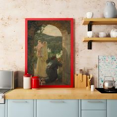 a painting hanging on the wall above a kitchen counter