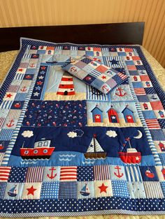 a quilted bed spread with boats, stars and stripes on the top is shown