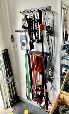 there is a rack full of skis and snowboards hanging from it's wall