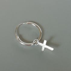 A PAIR of sterling silver hoops. Comes with a detachable dainty cross charm. The charm is multipurpose and can be used with a neck or bracelet chain too. Dimension: Hoop- 12 x 1 mm Charm- 5 x 8 mm Drop length- 20 mm Price listed is for ONE PAIR These are made of 925 hypoallergenic sterling silver. Most of my pieces come with a 925 stamp. Can be packaged in a gift box. I can include a personal message from you if needed You are welcome to contact me at... bhavnakwintra1956@gmail.com For more beau Silver Single Earring With Cross Pendant, Nickel-free Cross Hoop Earrings As Gift, Silver Nickel-free Cross Pendant Earrings, Nickel-free Cross Pendant Earrings In Sterling Silver, Nickel-free Sterling Silver Cross Earrings, Nickel-free Sterling Silver Cross Charm, Hoop Charms, Evil Eye Earrings, Thread Earrings