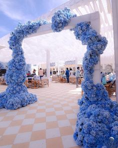 an outdoor wedding venue decorated with blue flowers