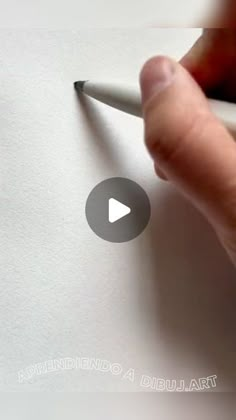 someone is writing on paper with a pen