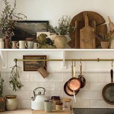 pots and pans are hanging on the wall