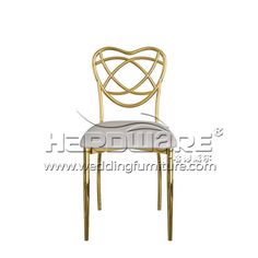 a gold metal chair with a white seat and back cushion on an isolated white background