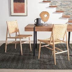 a dining room table with two chairs and a coffee cup on top of the table