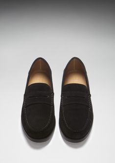 Here we offer you another Hugs & Co. take on a classic style. Our penny loafer upper made with carefully selected black Italian suede is teamed with a robust boat shoe sole in matching black rubber. This gives the shoes great wearability, fantastic comfort and the timeless style you're looking for in a penny loafer. We also offer loafers with tassels and driving shoes here at the Hugs & Co. online store. Our men's shoes are super cool and made to the tip top highest standards with leathers and suedes from England and Italy. If you're after preppy shoes or men's moccasins then you've come to the right place. UK Sizing Made in Portugal 100% Suede Upper featuring a 100% Leather Lining Rubber studded sole Black Old Money, Preppy Shoes, Moccasins Mens, Boat Shoe, Shoe Sole, Penny Loafer, Driving Shoes, Penny Loafers, Black Rubber