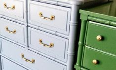 the drawers are painted green and blue with gold pulls on each drawer, which is also white