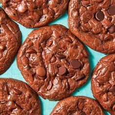 chocolate cookies with chocolate chips on a blue tablecloth, top view close up photo