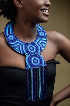 Unique Africa Maasai Handcrafted Leather Beaded Necklace with an Elegant Look and Brilliant Finish. Color = Different shades of blue. Length (Around Neck) =Adjustable. Length ( Downwards ) = 14 Inches / 37 Centimeters. **GET FREE SHIPPING FOR ADDITIONAL ITEMS PURCHASED. Yes, Buy Multiple Items and pay shipping for 1 item only- The rest ships Free. (No Limits on the number of Multiple items). With a faster delivery time of 3 days via DHLExpress, Worldwide. Ordinary/Standard Shipping also availabl Bohemian Blue Beaded Necklace, Blue Beads For Festivals, Blue Necklaces With Black Beads For Festival, Blue Necklace With Black Beads For Festival, Blue Round Bead Necklaces As Fashion Accessory, Blue Round Bead Necklaces, Blue Necklaces With Round Beads As Fashion Accessory, Blue Necklace With Round Beads As Fashion Accessory, Blue Adjustable Bib Necklace With Round Beads