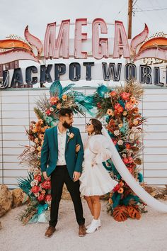 a man and woman standing in front of a sign