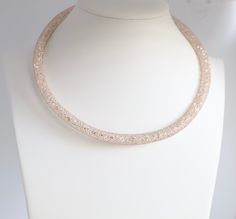 This necklace is made of gold and has a sparkle. It's a loop design that looks great on any woman. Elegant Rose Gold Crystal Necklaces For Party, Elegant Rose Gold Crystal Necklace For Parties, Adjustable Party Necklaces, Adjustable Round Necklaces For Party, Elegant Sparkling Choker Necklace, Elegant Sparkling Rose Gold Necklaces, Elegant Sparkling Rose Gold Necklace, Rose Gold Beaded Necklace For Party, Round Costume Jewelry Necklaces For Party