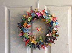 an origami wreath hanging on the front door