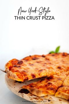 two slices of thin crust pizza on a plate with the words new york style thin crust pizza