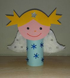 a paper cup with an angel cut out of it's head on a table