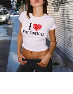 I love hot cowboys baby tee shirt/ I heart hot cowboys baby tee - distressed text, Cowgirl western aesthetic shirt, Crop top, Summer festival outfit, y2k baby tee, 90s tee, gift for her, gift for girlfriend, humor babytee Important: To achieve the Baby Tee look, we use Youth size heavy cotton Gildan 5000B tees. BEFORE ORDERING PLEASE MAKE SURE TO CHECK YOUR MEASUREMENTS.   Heavy Cotton Baby Tee Composition: Solid colors, 100% cotton Sport Grey - 90% cotton, 10% polyester The shoulders have twill Summer Graphic Tee With Heart Print, Trendy Heart Graphic T-shirt For Summer, Fitted Heart Print Top For Summer, Fitted Summer Top With Heart Print, Summer Cotton Top With Heart Print, Y2k Heart Print Top For Spring, Fitted Trendy Tops With Heart Print, Trendy Fitted Tops With Heart Print, Trendy Fitted Heart Print Tops