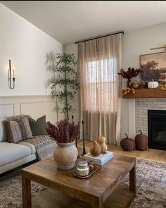 a living room filled with furniture and a fire place in front of a painting on the wall