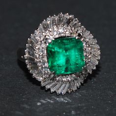 Fine Emerald Diamond Ring This emerald is natural and shows minor inclusions. It is a lovely gemstone, with excellent green color.  The origin is Columbian, 2.97CTS and hosts several baguette and round diamonds all around !  The total approx. diamond weight is 1.25CTS.  The piece is stamped stating size of emerald and diamond content.  The ring is platinum.   The overall measurement is approx. 7/8ths of an inch squared.  LorriMichelleJewelry Graduate Gemologist 625 South Hill St.B-70 Los Angeles, Calif. 9001`4 213-628-5032 Questions???? Luxury Baguette Cut Emerald Jewelry, Luxury Emerald Jewelry With Sparkling Stones, Columbian Emerald Engagement Ring, Colombian Emerald Earrings, Columbian Emeralds, Emerald Diamond Ring, Gold Sign, Dream Gift, Sparkling Rings