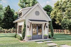 a small white house sitting in the middle of a yard