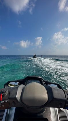 a motor boat traveling through the ocean on a sunny day