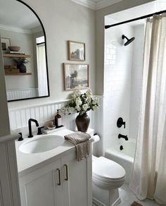 a bathroom with a sink, toilet and shower in it's centerpieces