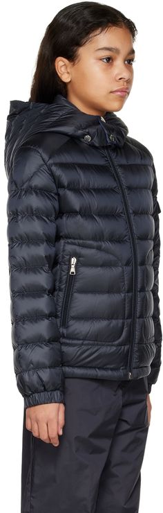 Down-filled quilted nylon satin jacket. · Detachable hood · Stand collar · Zip closure · Zip pockets · Elasticized hem and cuffs · Flap pocket and felted logo patch at sleeve · Full nylon satin lining · Hand-wash Supplier color: Navy Model measures 54 / 137.2 cm tall and wears size 10. Moncler Enfant Size: child's height 4: 42 / 104 cm 6: 45.7 / 116 cm 8: 51.2 / 130 cm 10: 55.2 / 140 cm 12: 59.8 / 152 cm 14: 64.6 / 164 cm Fill: 90% down, 10% feathers. Hooded Quilted Down Jacket With Pockets, Luxury Down Outerwear With Pockets, Luxury Nylon Outerwear With Pockets, Hooded Duck Down Outerwear With Ribbed Cuffs, Quilted Duck Down Hooded Puffer Jacket, Quilted Hooded Duck Down Puffer Jacket, Hooded Quilted Duck Down Jacket With Padded Collar, Luxury Quilted Hooded Outerwear, Hooded Quilted Nylon Jacket With Padded Collar