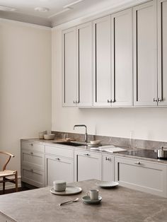 the kitchen is clean and ready to be used for breakfast or dinner time, with two cups on the counter