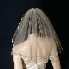 a mannequin wearing a wedding dress with a veil on it's head