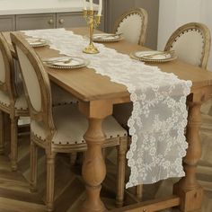 a dining room table with white lace on it