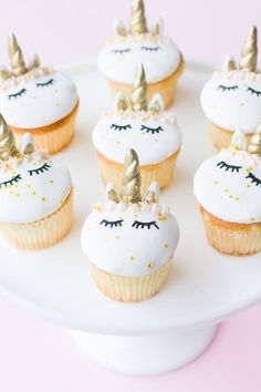 cupcakes decorated with white frosting and gold decorations