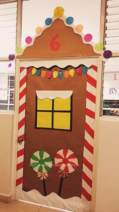 a door decorated to look like a gingerbread house with candy and lollipops