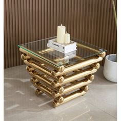 a stack of gold bamboo tables with candles on top