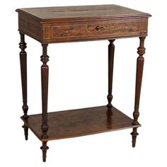 an antique wooden table with two drawers