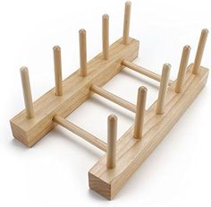 a wooden peg board with several posts in it