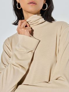 This versatile folded turtleneck top features side slits and a relaxed fit for that effortless cool factor without the fuss. (You might need every color). (This one comes in Champagne.) | Neo Top in Champagne | Ethical Essentials Oversized Turtleneck Top For Work, Solid Turtleneck Top With Relaxed Fit, Versatile Oversized Turtleneck Tops, Solid Color Relaxed Fit Turtleneck Top, Solid Relaxed Fit Turtleneck Top, Relaxed Fit Turtleneck Tops, Everyday Relaxed Fit Tops With Funnel Neck, Funnel Neck Tops With Relaxed Fit, Relaxed Fit Funnel Neck Top For Everyday