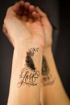 a woman's arm with a tattoo that says love and a feather on it