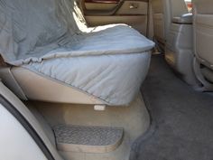 the back seat of a car with a mattress on it