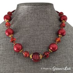 "Vintage single strand beaded necklace featuring mixed cranberry red beads with gold tone caps. The beads include round glass beads, glass bicone, a flat glass focal bead, and smaller plastic rondelle beads.  This bead necklace measures approximately 19\" long with a lobster claw clasp and it has a 3 1/2\" extender. Unsigned. Circa 1980s. This necklace is in very good vintage condition with some scuffs and crazing on the beads. Please see the pictures for details. Monitor resolution and lighting at the time the photos were taken could affect how the colors are seen in the photos. Please note that vintage items were cherished by a previous owner, and may have been worn. Thus vintage items are rarely in \"mint/perfect\" condition. Each vintage item is closely looked at before listed, and it Red Glass Beaded Necklaces With Polished Beads, Red Glass Necklace With Spacer Beads, Red Glass Bead Necklaces, Red Glass Round Bead Necklace, Red Glass Beaded Necklace With Large Beads, Red Glass Necklaces With Round Beads, Red Glass Necklace With Round Beads, Red Necklaces With Large Czech Glass Beads, Red Glass Beaded Necklaces With Round Beads