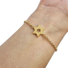 "This beautiful and stylish small gold Star of David bracelet is a staple piece of jewelry in anyone's wardrobe. The Star of David has long been a popular decorative motif on all sorts of Judaica, jewelry and art, owing to its beautiful geometric symmetry as well as its deep and powerful symbolism. 14K Gold Star of David Link Bracelet: Symbolic Elegance and Quality Craftsmanship for Meaningful Style Statements. This bracelet is a beautiful work of art that will make a precious gift to last for a lifetime. The jewelry will be packed in a gift box. Size: 14mm x 12mcm / 0.55\" x 0.45\" Dear Buyer,  My name is Rafael and my goal is to give you the best buying experience on Etsy I have a lot of experience in customer relations selling on the internet, and my goal is your 100% satisfaction guara Gold Bracelet With Star Charm, Gold Bracelet Jewelry With Star Charm, Adjustable Gold Star-shaped Chain Bracelet, Adjustable Gold Star Chain Bracelet, Adjustable Gold Chain Bracelet With Star Charm, Gold Metal Bracelet With Star Charm, Gold Metal Chain Bracelet With Star Charm, Gold Metal Bracelets With Star Charm, Adjustable Gold Star Bracelet