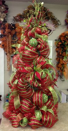 a red and green christmas tree sitting on top of a counter