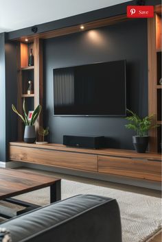 a living room with a large television on the wall and some plants in vases