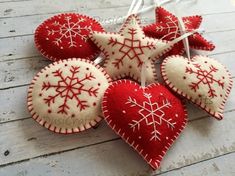 some red and white ornaments are hanging on a string with toothpicks in the shape of snowflakes