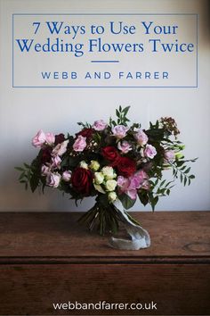 a bouquet of flowers sitting on top of a wooden table next to a sign that says 7 ways to use your wedding flowers twice