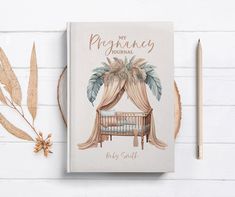 a baby's book with an image of a crib and leaves next to it