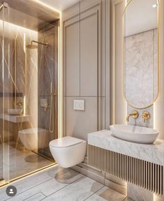 a modern bathroom with marble and gold accents