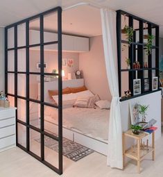 a bed room with a neatly made bed next to a wall mounted bookcases