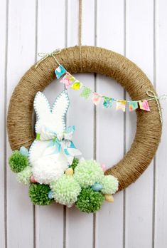 a wreath decorated with pom poms and an easter bunny