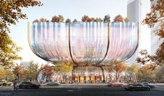 an artist's rendering of a futuristic building in the middle of a busy street